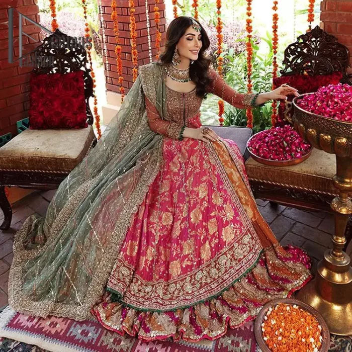 Be one with defying fashion winds and become a trendsetter. The captivating combination of front open style with the round neckline of shocking pink pishwas gives a stunning and smart look to you at any event. Pishwas is further furnished with attractive and handsome golden embroidery that includes mainly kora, dabka, and tilla work. Balance it with Rush Lehanga that have embellished with heavy border and sequins spray all-around to give soothing look. Complete this eventry look with a mint green dupatta that has been embellished with four-sided lace to give you a trendsetter look.