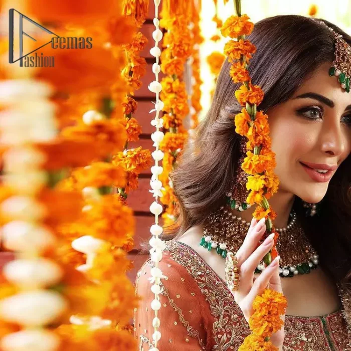 Be one with defying fashion winds and become a trendsetter. The captivating combination of front open style with the round neckline of shocking pink pishwas gives a stunning and smart look to you at any event. Pishwas is further furnished with attractive and handsome golden embroidery that includes mainly kora, dabka, and tilla work. Balance it with Rush Lehanga that have embellished with heavy border and sequins spray all-around to give soothing look. Complete this eventry look with a mint green dupatta that has been embellished with four-sided lace to give you a trendsetter look.