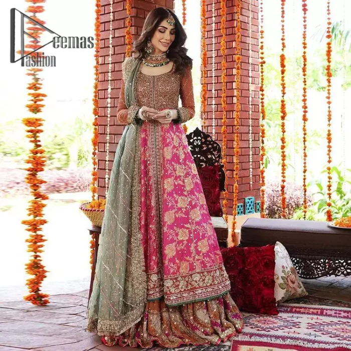 Be one with defying fashion winds and become a trendsetter. The captivating combination of front open style with the round neckline of shocking pink pishwas gives a stunning and smart look to you at any event. Pishwas is further furnished with attractive and handsome golden embroidery that includes mainly kora, dabka, and tilla work. Balance it with Rush Lehanga that have embellished with heavy border and sequins spray all-around to give soothing look. Complete this eventry look with a mint green dupatta that has been embellished with four-sided lace to give you a trendsetter look.