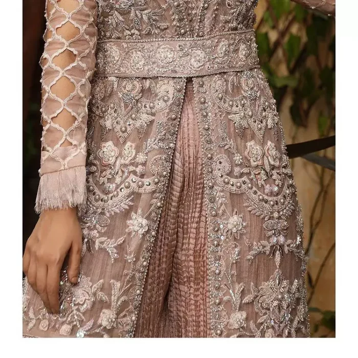 Nothing spells magic quite like a tea rose outfit on your big day. An engrossing shirt and crushed sharara style provide unparalleled majesty and impressiveness to the overall dress code all made with the purest of the tissue. This tea rose full sleeve shirt is heavily embellished with silver embroidery that includes pearls, kora and dabka work. Our attire and the way we put ourselves together sometimes speaks louder than our words. So, we set it up with tea rose crushed sharara to balance the magical fairytale look.