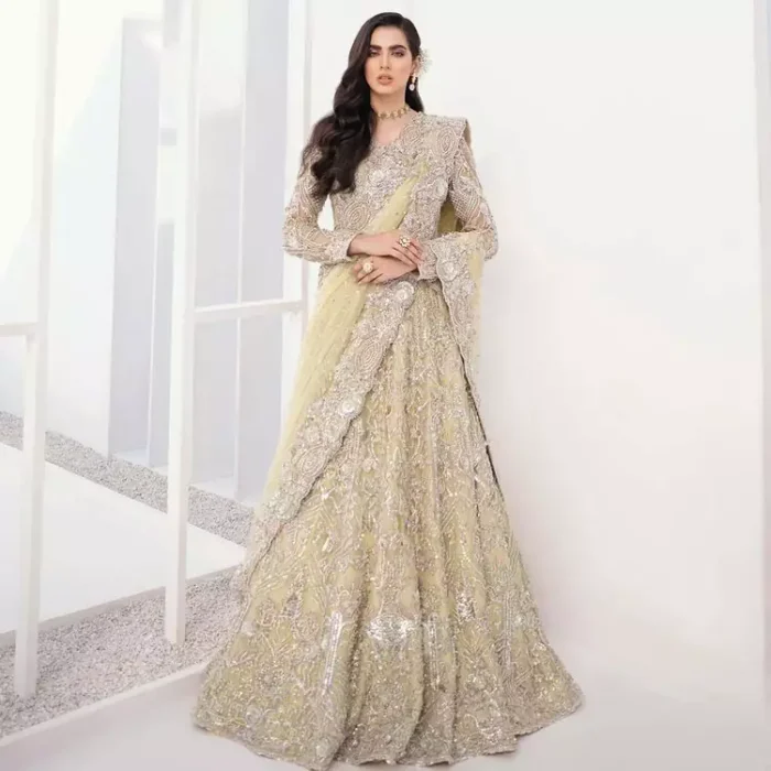 A dream come true for girls who love to play with their looks in a fashionable look. We don't even miss adding the finest details to our outfits so that's why the blouse is embellished with silver embroidery that involves kora, dabka, and tilla work to shoot up the first-rate look. Furthermore, the full sleeves of blouse and round neckline gives so splendid look when comes together.Gracefully, It is pair up with stunning and beautifull vanilla lehenga to fulfill your dream. Finish this look with dupatta that is embellished with four-sided borders and sequins spray all over to give you a fashionable look.