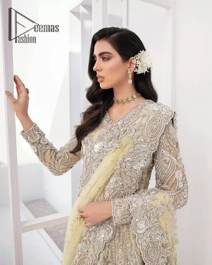 A dream come true for girls who love to play with their looks in a fashionable look. We don't even miss adding the finest details to our outfits so that's why the blouse is embellished with silver embroidery that involves kora, dabka, and tilla work to shoot up the first-rate look. Furthermore, the full sleeves of blouse and round neckline gives so splendid look when comes together.Gracefully, It is pair up with stunning and beautifull vanilla lehenga to fulfill your dream. Finish this look with dupatta that is embellished with four-sided borders and sequins spray all over to give you a fashionable look.