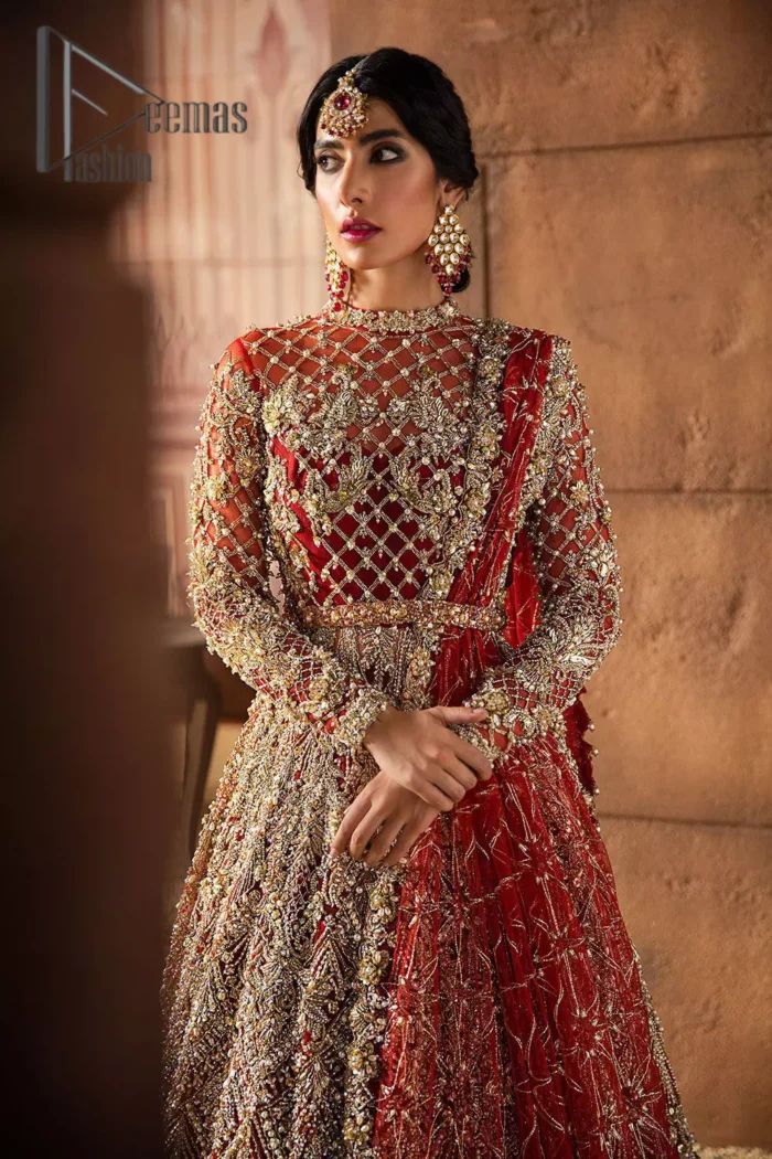 There are days in life when you fall in love with red love tone. As every bride wants red for her big day so DeemasFashion presents a bright red maxi that is heavily ornamented with golden embroidery just to make you a relaxing and romantic bride. The maxi is prominent with a jewel neckline which is added super aesthetics to your outfit. In addition to this, the full sleeves of maxi are just priceless and highlighted with kora, dabka, and tilla work. It is coordinated with the same color lehenga that's the border is heavily embellished with golden embroidery as well. Conclude this outfit with a bright red dupatta to add just the right amount to your bridal look.