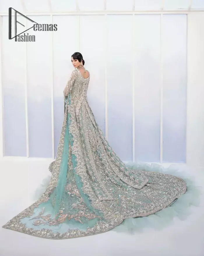 Sync. Style. Slay! A wedding is better when you get a super stylish all-in-one. DeemasFashion presents you with an ice-blue front open maxi this is decorated with silver embroidery which involves tilla, dabka, kora, and pearls work to magnify your inner pleasure on your Walima day. It is dominant with full sleeves just to grant you an aesthetic look. It is attractively coordinated with an ice blue lehenga with back train styling to give you a fairy look. Complete this outfit with the same colour dupatta that is beautifully embellished with floral motifs and a four-sided border.