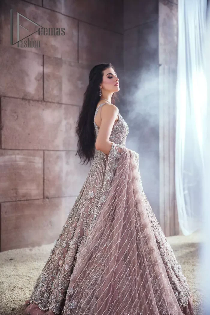 Rose, glitter, and glam are the mood. Shine through with all eyes on you! A full festive package dipped in an oyster pink tone. Presenting oyster pink front open maxi for your Walima day just to boost up your inner happiness. The maxi is handsomely adorned with silver embroidery that is embellished with tilla, kora, dabka, and pearls work. Furthermore, it is highlighted with full sleeves just to give you glam and shiny look. It is systemized with an oyster pink lehenga to give you a superstar look. End up this article with the same colour dupatta that is prominent with a four-sided embellished border and sequins spray all over.