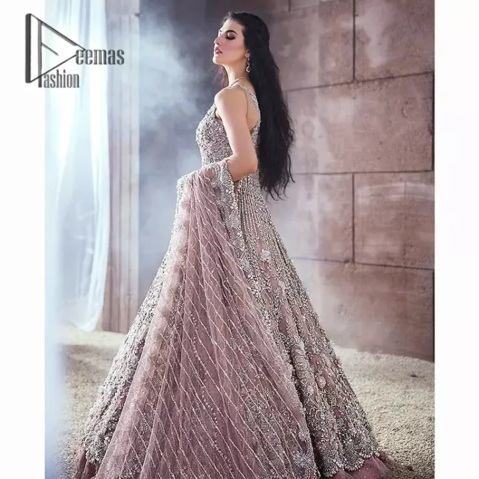 Rose, glitter, and glam are the mood. Shine through with all eyes on you! A full festive package dipped in an oyster pink tone. Presenting oyster pink front open maxi for your Walima day just to boost up your inner happiness. The maxi is handsomely adorned with silver embroidery that is embellished with tilla, kora, dabka, and pearls work. Furthermore, it is highlighted with full sleeves just to give you glam and shiny look. It is systemized with an oyster pink lehenga to give you a superstar look. End up this article with the same colour dupatta that is prominent with a four-sided embellished border and sequins spray all over.