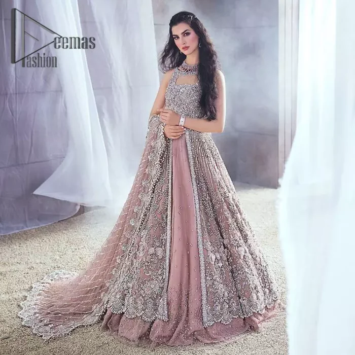 Rose, glitter, and glam are the mood. Shine through with all eyes on you! A full festive package dipped in an oyster pink tone. Presenting oyster pink front open maxi for your Walima day just to boost up your inner happiness. The maxi is handsomely adorned with silver embroidery that is embellished with tilla, kora, dabka, and pearls work. Furthermore, it is highlighted with full sleeves just to give you glam and shiny look. It is systemized with an oyster pink lehenga to give you a superstar look. End up this article with the same colour dupatta that is prominent with a four-sided embellished border and sequins spray all over.