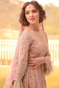 There is nothing more magical than wearing pink colour on your Walima. Our pink side slit open maxi is handsomely embellished with the magic of silver embroidery that involves kora, antiques, dabka, sequins, and pearls just to give you a dream fairy look. Further, the back train of the maxi is granted you the super dazzling effect. It is beautifully organized with a pink dupatta that is embellished with four-sided borders. Further, the dupatta is highlighted with the spray of tiny floral motifs all over just to enhance the fairy look.