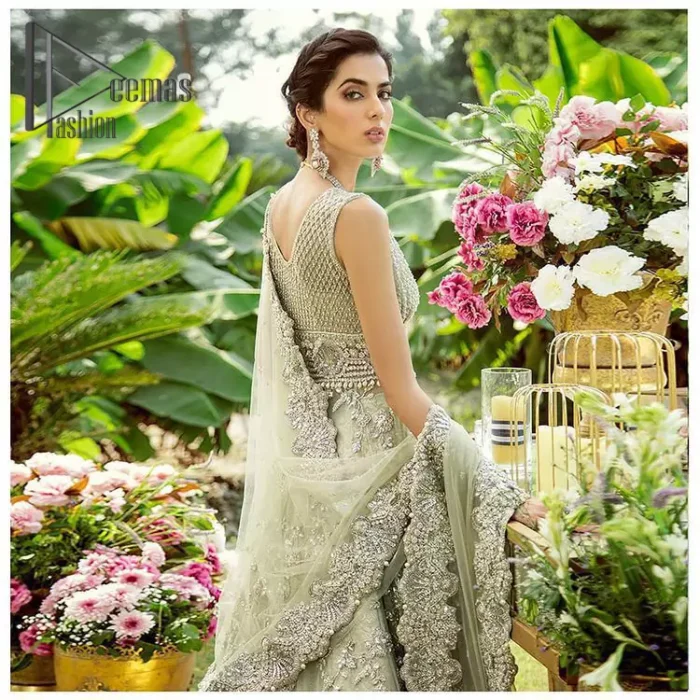Dare to wear, Oh so bling and slaying like never before. It's an outfit of power and glam. The pistachio green maxi is a breathtaking assortment of sequins, pearls and crystals. The V shape neckline has enhanced the beauty of this pistachio maxi which is attractively combined with a sleeveless style. Further, it is prominent with silver and light golden embroidery. Pair up this maxi with the same colour lehenga. Complete this article with a dupatta which is intensified with intricate embroidered border and sequins spray all so you can steal everyone's heart on your walima day.