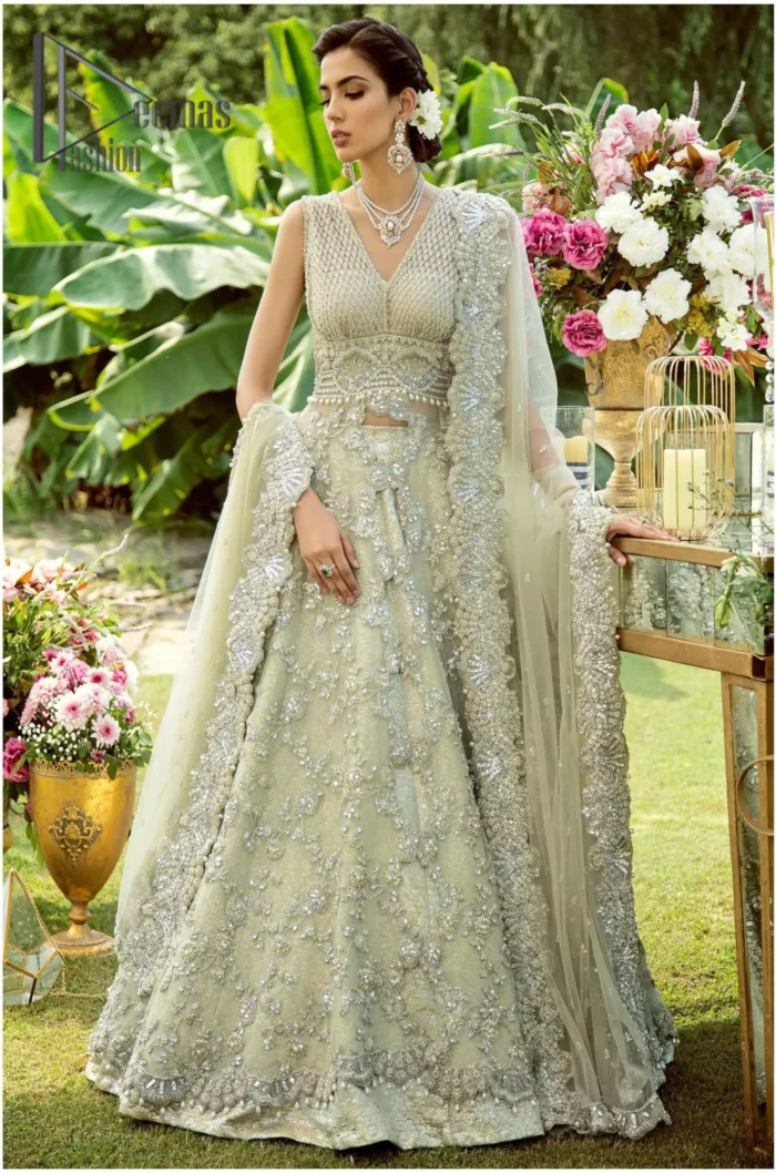 Dare to wear, Oh so bling and slaying like never before. It's an outfit of power and glam. The pistachio green maxi is a breathtaking assortment of sequins, pearls and crystals. The V shape neckline has enhanced the beauty of this pistachio maxi which is attractively combined with a sleeveless style. Further, it is prominent with silver and light golden embroidery. Pair up this maxi with the same colour lehenga. Complete this article with a dupatta which is intensified with intricate embroidered border and sequins spray all so you can steal everyone's heart on your walima day.