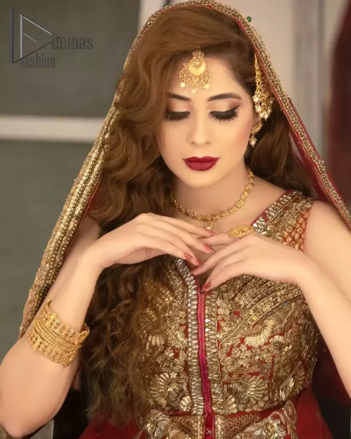 She's a divine, a diety, a vision, a gift. She is a girl in Florence, wrapped in a flare and dreaming about her big day. Welcoming your guest in the red front open maxi which is handsomely decorated with beautiful embroidery. It is reflected with golden tilla, kora, zardozi and pearls. The maxi is further intensified with V shape neckline with a sleeveless style. It is synchronized with a red dupatta that is also embellished with a four-sided golden embroidery. Further, the dupatta is adorned with floral motifs and sequins sprayed all over so that you can achieve your dreamy look on your big day.