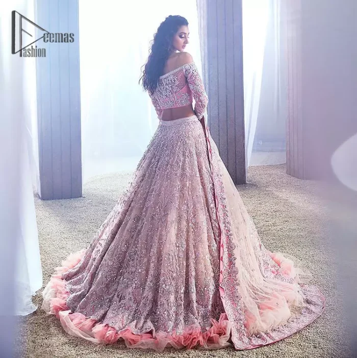 DeemasFashion just defines sophistication and minimal high fashion in terms you desire. Reveal your aura in this tea pink off-shoulder blouse that is beautifully decorated with silver embroidery that involves a kora, dabka, tilla, and crystal look just to grant you mesmerizing look. Further, the full sleeves of the blouse look so admiring on your walima day. It is arranged with a frilled lehenga again which is ornamented with heavy silver embroidery so that you can steal everyone's heart. Finish this article with a tea pink dupatta that is prominent with four-sided border embellishment.