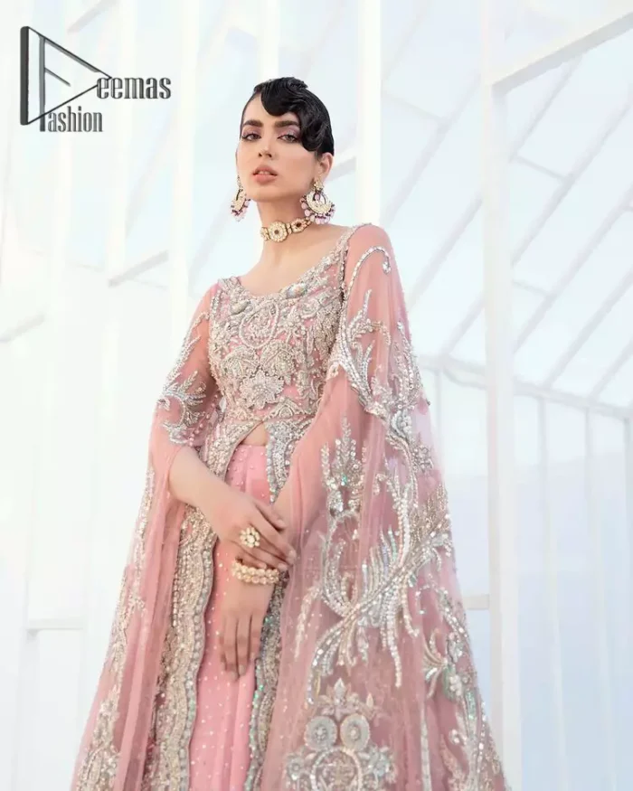 Wants regal, striking, and bold? Our tea pink maxi is all you need to bring out the queen in you. Detailing this tea pink maxi is as amazing as the front open style of maxi. Maxi is prominent with silver embroidery that involves kora, dabka, tilla, and crystal work to give you a bold and regal look on your walima day. Further, it looks super stunning when full sleeves combine with a round neckline. The maxi is coordinated with a double tone lehenga that the bottom side reflects the yellow colour to give an aesthetic and stunning look. Complete this article with the same colour dupatta that is embellished with a four-sided border.
