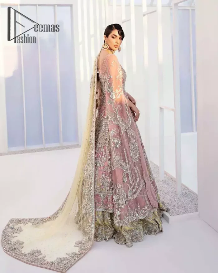 Wants regal, striking, and bold? Our tea pink maxi is all you need to bring out the queen in you. Detailing this tea pink maxi is as amazing as the front open style of maxi. Maxi is prominent with silver embroidery that involves kora, dabka, tilla, and crystal work to give you a bold and regal look on your walima day. Further, it looks super stunning when full sleeves combine with a round neckline. The maxi is coordinated with a double tone lehenga that the bottom side reflects the yellow colour to give an aesthetic and stunning look. Complete this article with the same colour dupatta that is embellished with a four-sided border.