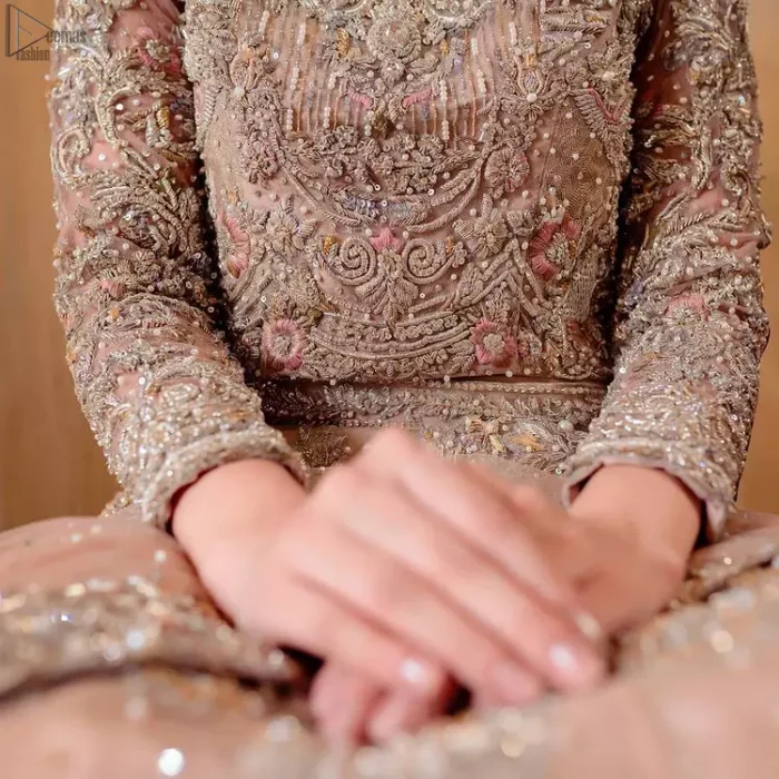As a symbol of intense beauty and delicacy, our professional designers symbolized rose with the Tea Rose Lehenga Blouse due to its rose-like elegance and charm. An exceptionally ravishing bridal wear, specially designed in full sleeves and a graceful round neckline to give it a marvellous traditional sense. A glamorous work of silver and gold embroidery and adornment of meritorious floral motifs contributes to the supremacy of this admirable attire. The dress is made with the purest organza and follows a lehenga and a gorgeous net dupatta, finally concluding the stunning dress code and setting the dress ready for your Walima.