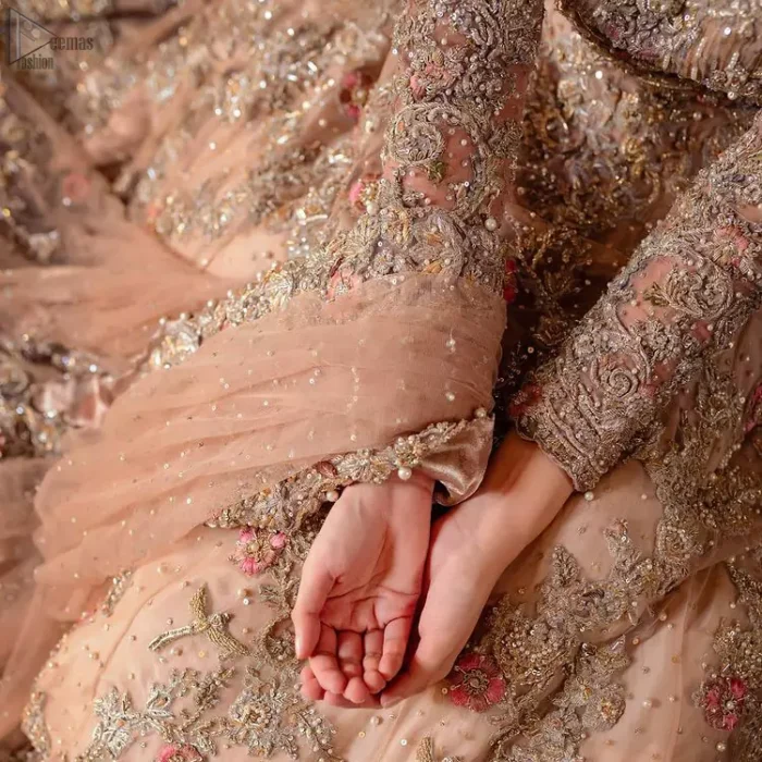 As a symbol of intense beauty and delicacy, our professional designers symbolized rose with the Tea Rose Lehenga Blouse due to its rose-like elegance and charm. An exceptionally ravishing bridal wear, specially designed in full sleeves and a graceful round neckline to give it a marvellous traditional sense. A glamorous work of silver and gold embroidery and adornment of meritorious floral motifs contributes to the supremacy of this admirable attire. The dress is made with the purest organza and follows a lehenga and a gorgeous net dupatta, finally concluding the stunning dress code and setting the dress ready for your Walima.