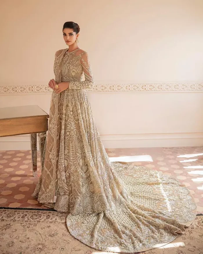Something to Beige about! This article is specially presented by DeemasFashion featuring thoughtfully designed ensembles with a rich beige colour maxi and dupatta that are flattering on the body's quintessential details. The round neckline of the maxi is attractively combined with the back train that is heavily adorned with silver dabka, tilla,m zardozi embroidery for the finest look. In addition to this, it is paired up with the same colour dupatta that is again ornamented with \a four-sided border and sequins spray all over to fulfil your finest promising look on your walima day. 