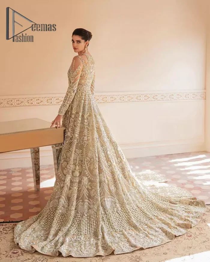 Something to Beige about! This article is specially presented by DeemasFashion featuring thoughtfully designed ensembles with a rich beige colour maxi and dupatta that are flattering on the body's quintessential details. The round neckline of the maxi is attractively combined with the back train that is heavily adorned with silver dabka, tilla,m zardozi embroidery for the finest look. In addition to this, it is paired up with the same colour dupatta that is again ornamented with \a four-sided border and sequins spray all over to fulfil your finest promising look on your walima day. 