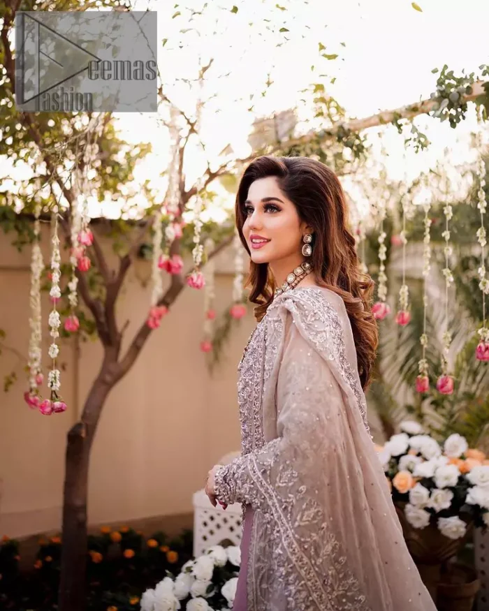Embrace happiness on your Walima in the colour of beige-pink along this dreamiest fairy tail maxi. The floral fusion of tilla and thread embroidery on a royal beige-pink maxi is to fulfil your dreamy look. The boat shape neckline of this maxi is as amazing as the whole maxi. Further, it is fully embellished with tilla, kora, dabka and sequins work just to enhance the beauty of your Walima day. The fairy tale is also adorned with heavy work and looks super amazing when combine with full sleeves style. Finish this fairy look with the same colour dupatta that is ornamented with a four-sided border and sequins sprayed all over to increase the look of this article.