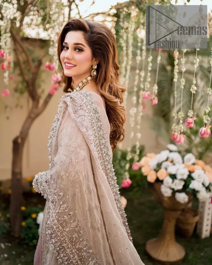 Embrace happiness on your Walima in the colour of beige-pink along this dreamiest fairy tail maxi. The floral fusion of tilla and thread embroidery on a royal beige-pink maxi is to fulfil your dreamy look. The boat shape neckline of this maxi is as amazing as the whole maxi. Further, it is fully embellished with tilla, kora, dabka and sequins work just to enhance the beauty of your Walima day. The fairy tale is also adorned with heavy work and looks super amazing when combine with full sleeves style. Finish this fairy look with the same colour dupatta that is ornamented with a four-sided border and sequins sprayed all over to increase the look of this article.