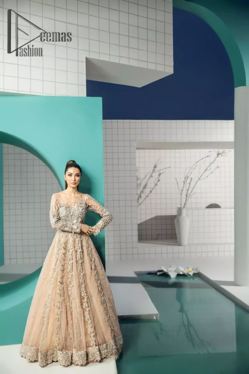 Unleashing your inner evocation of feeling about love and imagination. The Beige scalloped maxi is attractively adorned with silver embroidery which is the true depiction of the origination of art. It is highlighted with kora, dabka, tilla and pearls to show the uniqueness of the outfit. Furthermore, it is organized with boat shape neckline and full sleeves to grant the feeling of imagination. Pair up with a fluffy lehenga to enhance the fairy and dreamy look of you on your walima day.