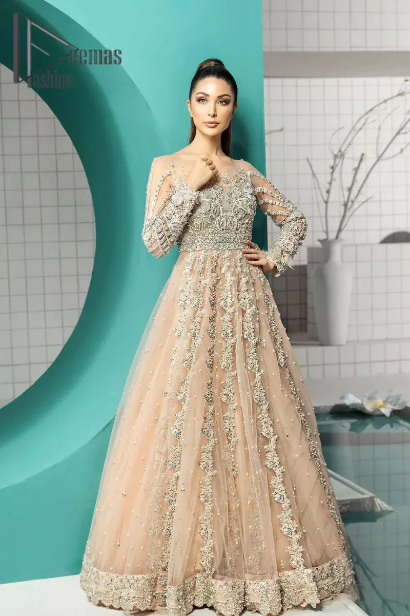 Unleashing your inner evocation of feeling about love and imagination. The Beige scalloped maxi is attractively adorned with silver embroidery which is the true depiction of the origination of art. It is highlighted with kora, dabka, tilla and pearls to show the uniqueness of the outfit. Furthermore, it is organized with boat shape neckline and full sleeves to grant the feeling of imagination. Pair up with a fluffy lehenga to enhance the fairy and dreamy look of you on your walima day.