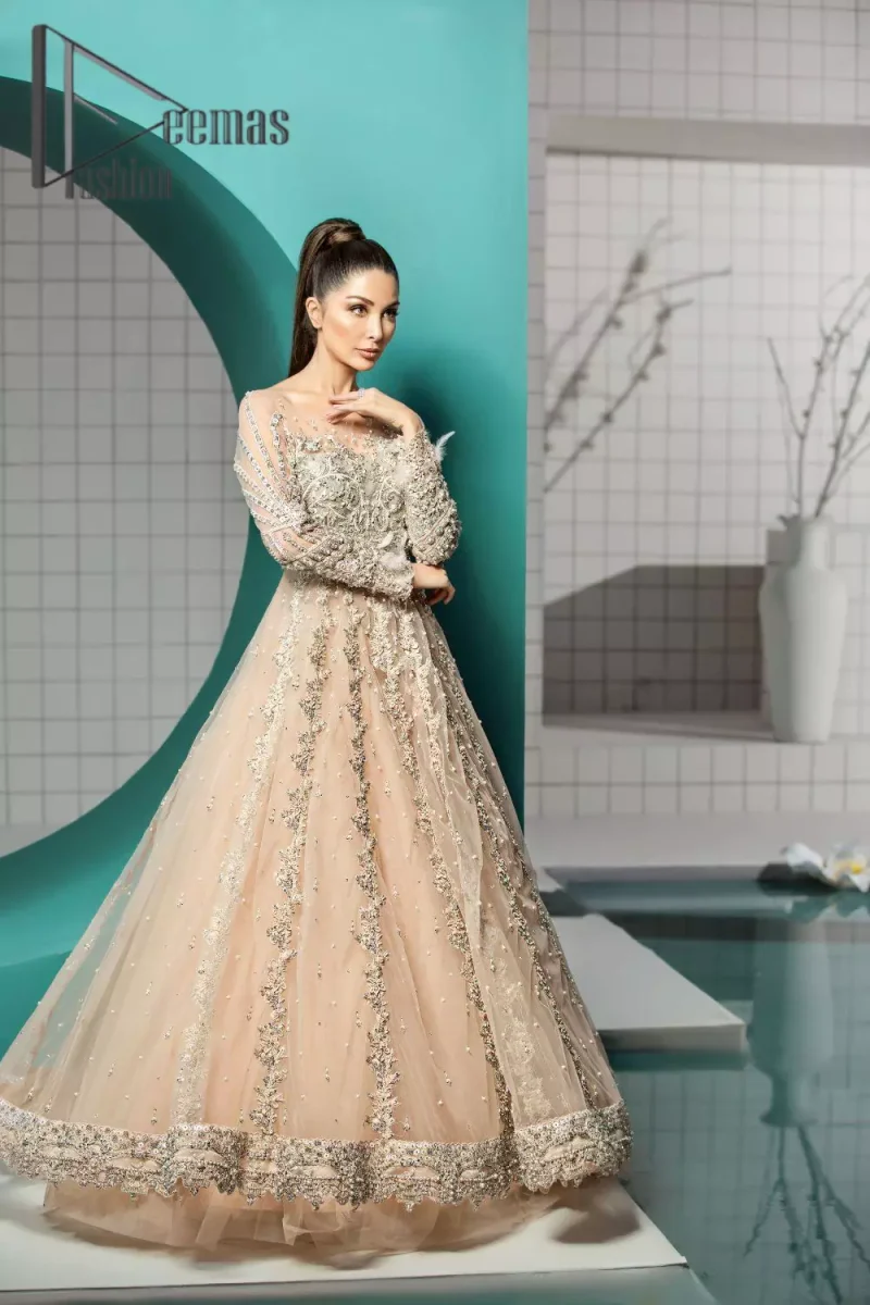 Unleashing your inner evocation of feeling about love and imagination. The Beige scalloped maxi is attractively adorned with silver embroidery which is the true depiction of the origination of art. It is highlighted with kora, dabka, tilla and pearls to show the uniqueness of the outfit. Furthermore, it is organized with boat shape neckline and full sleeves to grant the feeling of imagination. Pair up with a fluffy lehenga to enhance the fairy and dreamy look of you on your walima day.