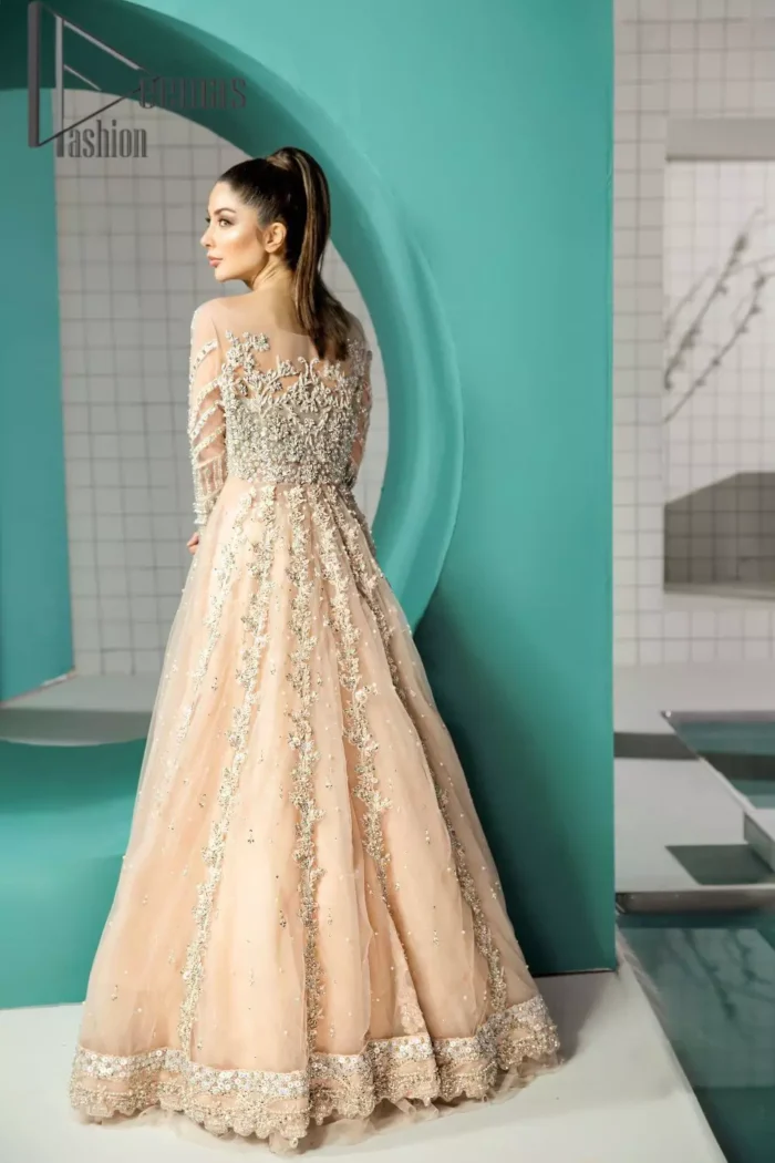 Unleashing your inner evocation of feeling about love and imagination. The Beige scalloped maxi is attractively adorned with silver embroidery which is the true depiction of the origination of art. It is highlighted with kora, dabka, tilla and pearls to show the uniqueness of the outfit. Furthermore, it is organized with boat shape neckline and full sleeves to grant the feeling of imagination. Pair up with a fluffy lehenga to enhance the fairy and dreamy look of you on your walima day. 