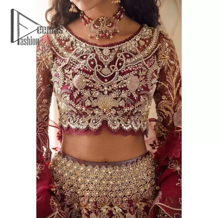 Create your own uniqueness. Let it be priceless for yourself and yet identifiable for others. Introducing burgundy blouse which is heavily adorned with golden embroidery that includes kora, doabka and magic of tilla. It is enhanced with the round shape neckline and full sleeves to make your remarkable moments lovely and a little romantic. Furthermore, it is systemized with a frilled lehenga that is again embellished with heavy embroidery. Finish this outfit with a scalloped dupatta in the same colour that is ornamented with a four-sided border to make you the priceless bride. 
