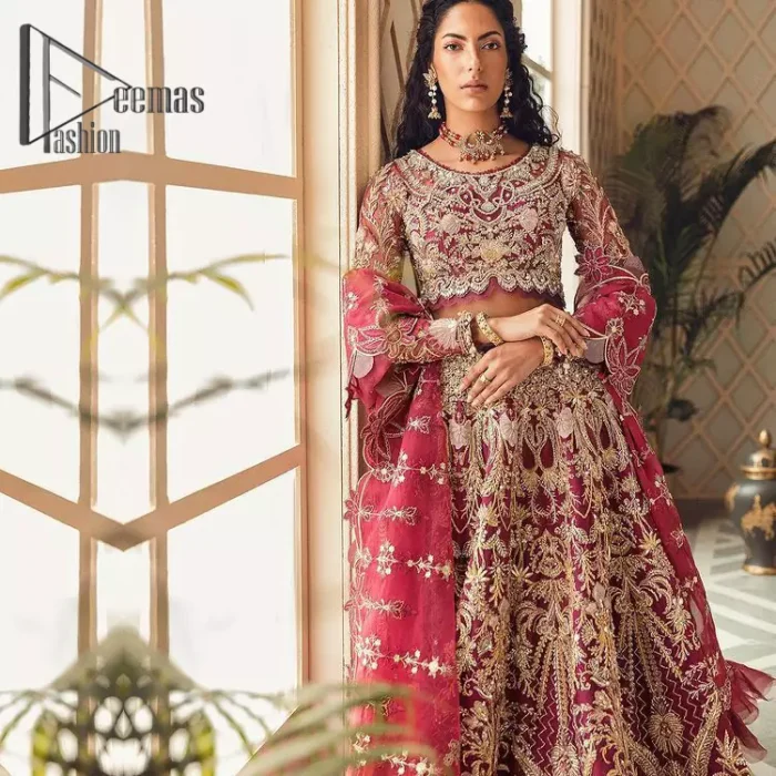 Create your own uniqueness. Let it be priceless for yourself and yet identifiable for others. Introducing burgundy blouse which is heavily adorned with golden embroidery that includes kora, doabka and magic of tilla. It is enhanced with the round shape neckline and full sleeves to make your remarkable moments lovely and a little romantic. Furthermore, it is systemized with a frilled lehenga that is again embellished with heavy embroidery. Finish this outfit with a scalloped dupatta in the same colour that is ornamented with a four-sided border to make you the priceless bride. 