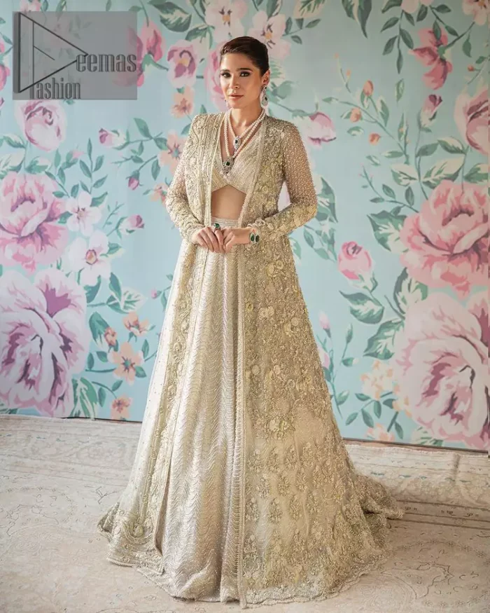 On a magical ivory afternoon, the sun reflects her radiance, the wind mimics her gaze. Starting this ivory article with an attractive and romantic blouse that is beautifully adorned with the same colour embroidery. The V shape neckline of the blouse adds a lovely feeling as well. In addition to this, it is organized with the same colour front open gown that is heavily adorned with tilla, dabka, kora and pearls embroidery. It is highlighted with full sleeves style that shows the uniqueness of the article. Paired up with the same colour lehenga to boost up the walima day of every bride. Complete this article with an ivory dupatta that is embellished with four-sided borders and sequins spray and tiny floral motifs spread all over. 