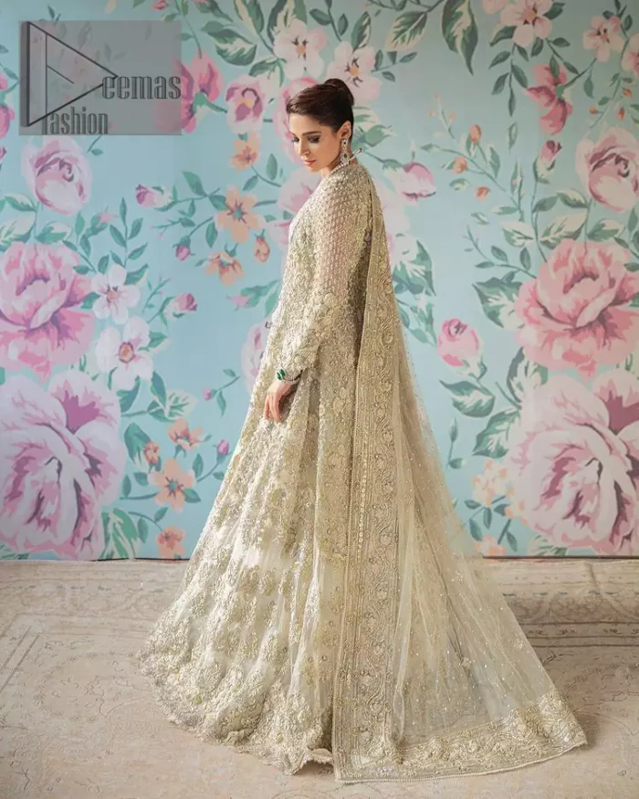On a magical ivory afternoon, the sun reflects her radiance, the wind mimics her gaze. Starting this ivory article with an attractive and romantic blouse that is beautifully adorned with the same colour embroidery. The V shape neckline of the blouse adds a lovely feeling as well. In addition to this, it is organized with the same colour front open gown that is heavily adorned with tilla, dabka, kora and pearls embroidery. It is highlighted with full sleeves style that shows the uniqueness of the article. Paired up with the same colour lehenga to boost up the walima day of every bride. Complete this article with an ivory dupatta that is embellished with four-sided borders and sequins spray and tiny floral motifs spread all over. 