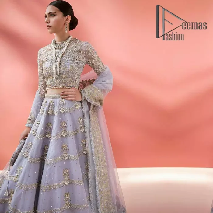 Love when our brides can completely be lost in the moment with their dresses. DeemasFashion presents a lilac article which is starting with a lilac blouse that is ornamented with golden embroidery. It is highlighted with tilla, dabka, pearls and the illusion of crystals. Furthermore, the full sleeves of the dress are attractively designed with a round shape neckline to boost your feelings on your walima day. It is handsomely coordinated with the same colour lehenga that is again embellished with golden embroidery. End up this outfit with the same colour dupatta that is embellished with four-sided borders and sequins sprayed all over to make a memorable event for the bride. 