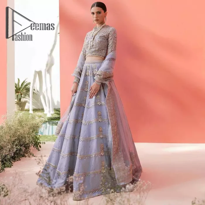 Love when our brides can completely be lost in the moment with their dresses. DeemasFashion presents a lilac article which is starting with a lilac blouse that is ornamented with golden embroidery. It is highlighted with tilla, dabka, pearls and the illusion of crystals. Furthermore, the full sleeves of the dress are attractively designed with a round shape neckline to boost your feelings on your walima day. It is handsomely coordinated with the same colour lehenga that is again embellished with golden embroidery. End up this outfit with the same colour dupatta that is embellished with four-sided borders and sequins sprayed all over to make a memorable event for the bride. 