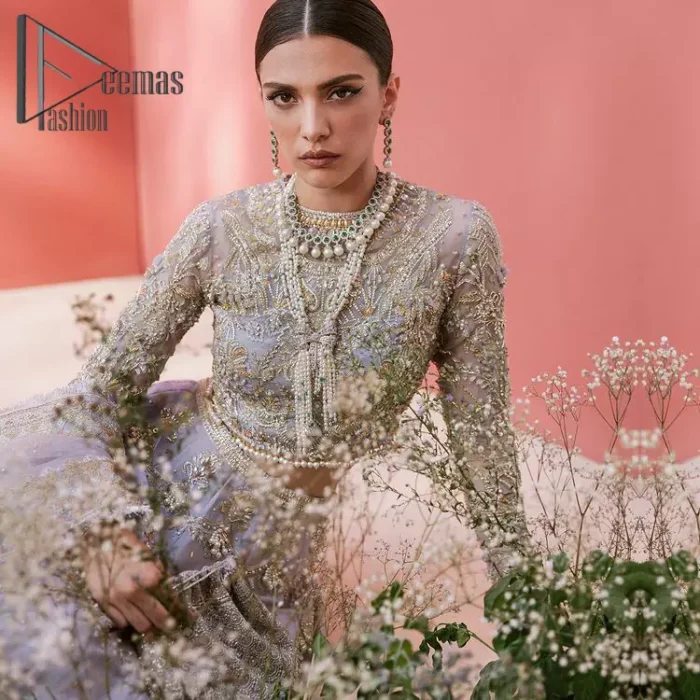 Love when our brides can completely be lost in the moment with their dresses. DeemasFashion presents a lilac article which is starting with a lilac blouse that is ornamented with golden embroidery. It is highlighted with tilla, dabka, pearls and the illusion of crystals. Furthermore, the full sleeves of the dress are attractively designed with a round shape neckline to boost your feelings on your walima day. It is handsomely coordinated with the same colour lehenga that is again embellished with golden embroidery. End up this outfit with the same colour dupatta that is embellished with four-sided borders and sequins sprayed all over to make a memorable event for the bride. 
