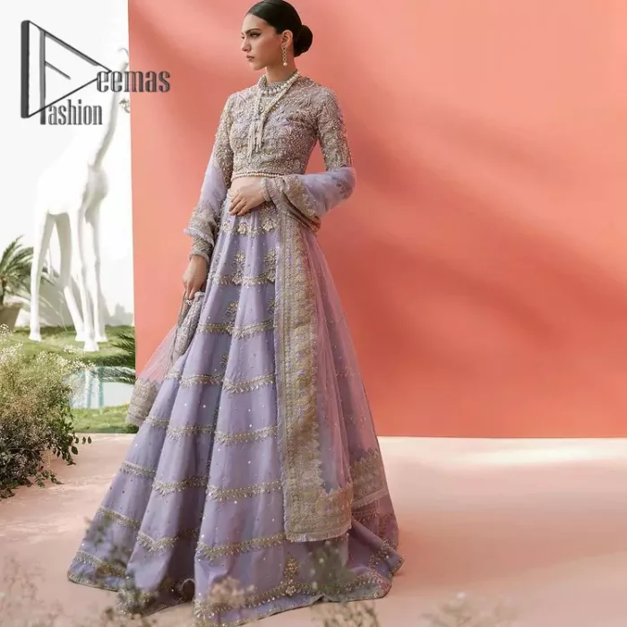 Love when our brides can completely be lost in the moment with their dresses. DeemasFashion presents a lilac article which is starting with a lilac blouse that is ornamented with golden embroidery. It is highlighted with tilla, dabka, pearls and the illusion of crystals. Furthermore, the full sleeves of the dress are attractively designed with a round shape neckline to boost your feelings on your walima day. It is handsomely coordinated with the same colour lehenga that is again embellished with golden embroidery. End up this outfit with the same colour dupatta that is embellished with four-sided borders and sequins sprayed all over to make a memorable event for the bride. 