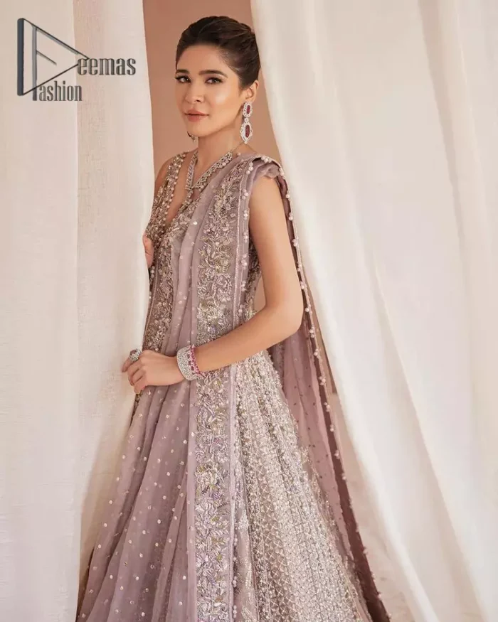 We know for most the girls a wedding dress represents more than just love. For our real brides, we present a lilac multiple panel maxi which is the embodiment of a dream and beautifully embellished with silver tilla, dabka and kora work. Furthermore, the sleeveless style of this multiple panel maxi is super amazing with V shape neckline just to introduce our love for the brides. This lilac maxi is organized with golden lehenga just to give the contrast to your walima day which is embellished with embroidery. Finish this look with a lilac dupatta which is heavily embellished with a four-sided border and sequins sprayed all over.