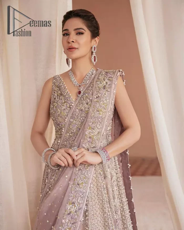 We know for most the girls a wedding dress represents more than just love. For our real brides, we present a lilac multiple panel maxi which is the embodiment of a dream and beautifully embellished with silver tilla, dabka and kora work. Furthermore, the sleeveless style of this multiple panel maxi is super amazing with V shape neckline just to introduce our love for the brides. This lilac maxi is organized with golden lehenga just to give the contrast to your walima day which is embellished with embroidery. Finish this look with a lilac dupatta which is heavily embellished with a four-sided border and sequins sprayed all over.