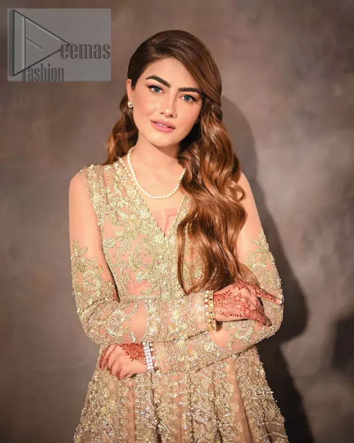 Its lustrous, lush and lavish in every sense of the word with its dazzling nude peach base. The nude peach multiple panel frock is amazing for your walima day. The V shape neckline is heavily embellished with embroidery. Further, this aesthetic nude peach frock is enhanced with silver pearls, tilla and dabka work. It is prominent with full sleeves that give a soothing effect to this article. It is complete in its pleasing loudness with an equal nude peach sharara that is adorned with silver embroidery just to fulfil the fairy dream of every bride. 