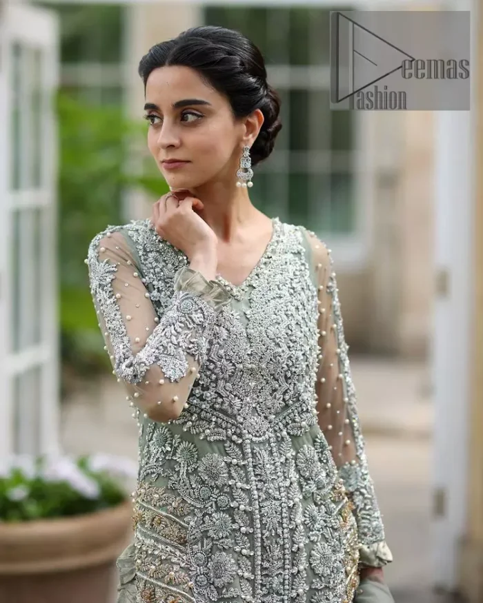 The subtle but powerful action.DeemasFashion presents pastel green outfits just to grant you modern, light and easy-breezy vibes at any party. The floor-length shirt of this article is attractively adorned with silver embroidery which is highlighted with kora, dabka, tilla and crystal work. In addition to this, the V shape neckline and full sleeves enhance the beauty of the article as you are the star of the party.  it is coordinated with the same colour plain trouser that balances the look of the article. Finish this pastel green dress with the same colour dupatta that is adorned with sequins spray all over as you can steal everyone's heart on any occasion. 