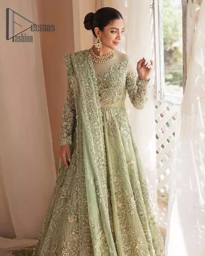 A time of life that is not just an occasion but a celebration. A pastel green scalloped maxi laboriously frosted with meticulously detailed hand embellished with silver tilla, dabka, and kora work blooming all over. Further, the jewel neckline and full sleeves of this article give so soothing feeling to you your walima day. It is handsomely coordinated with a pastel green lehenga that is again beautifully embellished. Complete this article with the organza dupatta in the same colour, heavily laden with a four-sided border and tiny floral motifs all over with a magical stream of pearls. 