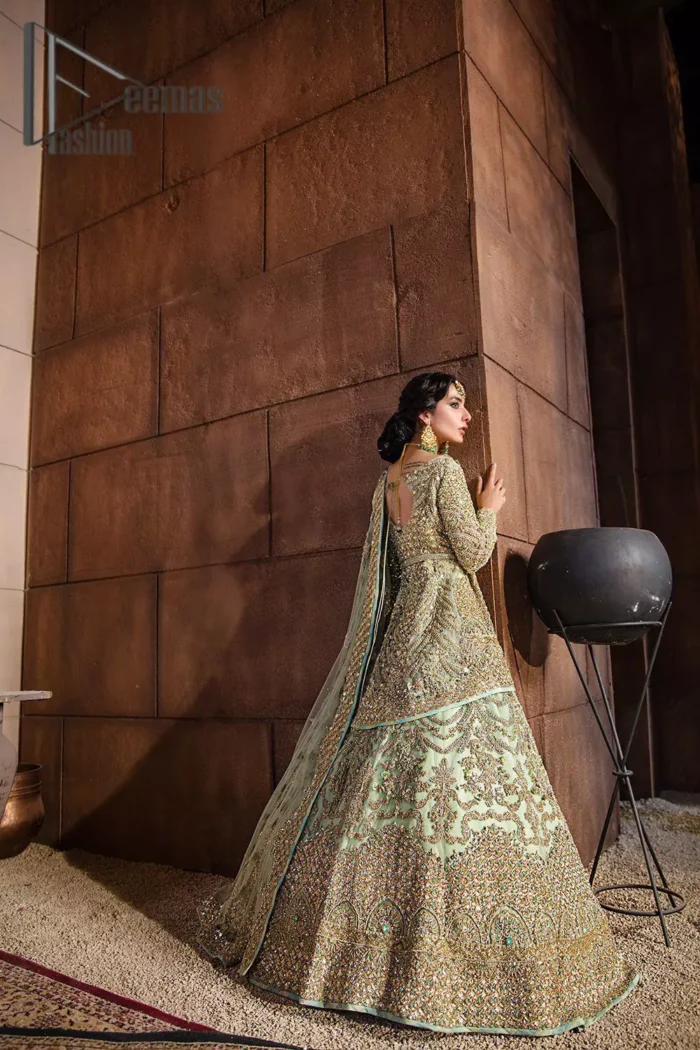 She was a dreamer, and so are we. A pistachio green front open short frock serves as a canvas for gold and pistachio green work with the magic of tilla, dabka, semi-precious stones and pearls. The V shape neckline is highlighted with full sleeves to add a galaxy in eyes of every bride. In addition to this, it is organized with the same colour fluffy lehenga which is again adorned with heavy golden embroidery to express the love of the bride on her walima day. Finish this outfit with the same colour dupatta which is embellished with four-sided borders and sequins sprayed all over.  