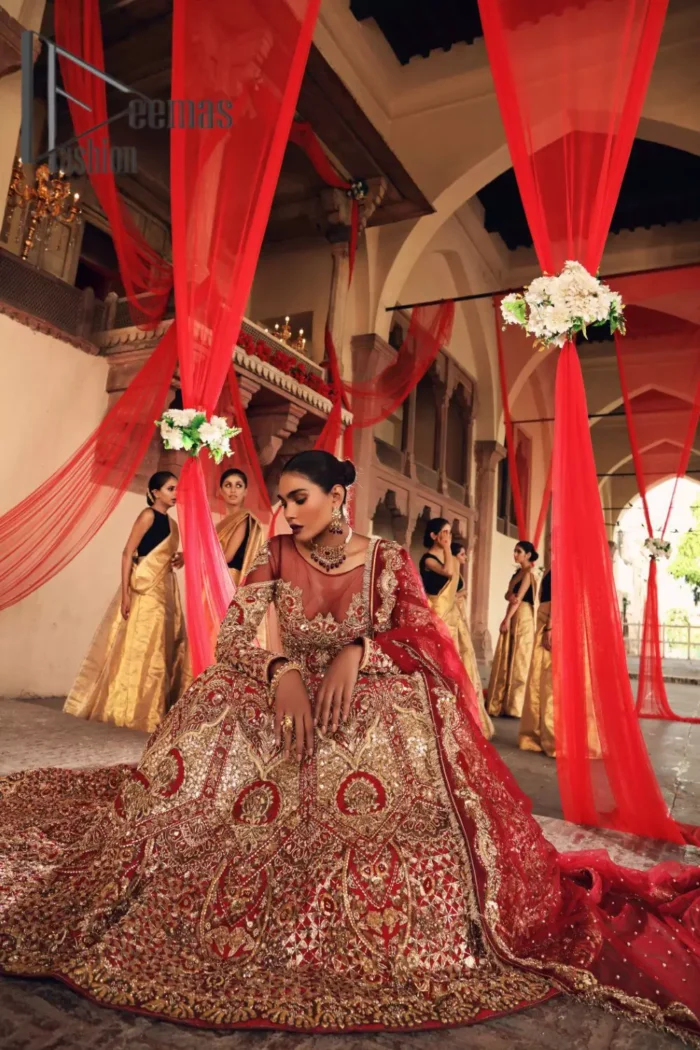 Celebrate the most romantic moments of your Big Day in the style of DeemasFashion. The red blouse represents the love in the air with handsomely embellished golden embroidery which includes kora, dabka, tilla and zardozi. It is prominent with an illusion neck and combine with full sleeves to enhance the love of you for your lovely audience. It is coordinated with a lehenga which is heavily adorned with the finest embroidery and looks super splendid as well. Complete this lovely article with the same colour dupatta that is adorned with a four-sided border and sequins sprayed all over to give you the romantic look.