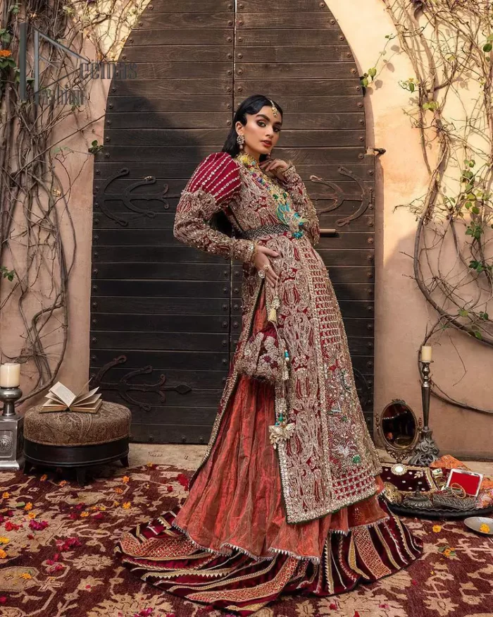 Look in my eyes, look how they shine for you and everything you do. DeemasFashion presents a very traditional outfit for the brides to wear the article on their Big Day. The traditional red long shirt is hand-rendered in silver and is enhanced with Resham, tilla, pearls, Sitara and naqshi. The V shape neckline and full sleeves added some magic and a dramatic look to the bride. Further, it is prominent with a blue heavy floral motif that is placed at the centre. The long shirt is organized with crushed share that truly defines the love and laughter of a bride. 