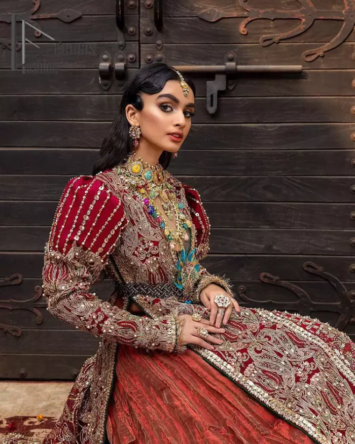 Look in my eyes, look how they shine for you and everything you do. DeemasFashion presents a very traditional outfit for the brides to wear the article on their Big Day. The traditional red long shirt is hand-rendered in silver and is enhanced with Resham, tilla, pearls, Sitara and naqshi. The V shape neckline and full sleeves added some magic and a dramatic look to the bride. Further, it is prominent with a blue heavy floral motif that is placed at the centre. The long shirt is organized with crushed share that truly defines the love and laughter of a bride. 