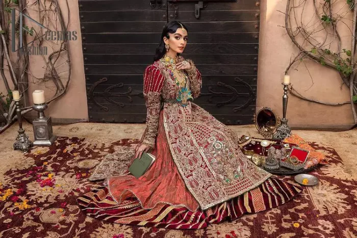 Look in my eyes, look how they shine for you and everything you do. DeemasFashion presents a very traditional outfit for the brides to wear the article on their Big Day. The traditional red long shirt is hand-rendered in silver and is enhanced with Resham, tilla, pearls, Sitara and naqshi. The V shape neckline and full sleeves added some magic and a dramatic look to the bride. Further, it is prominent with a blue heavy floral motif that is placed at the centre. The long shirt is organized with crushed share that truly defines the love and laughter of a bride. 
