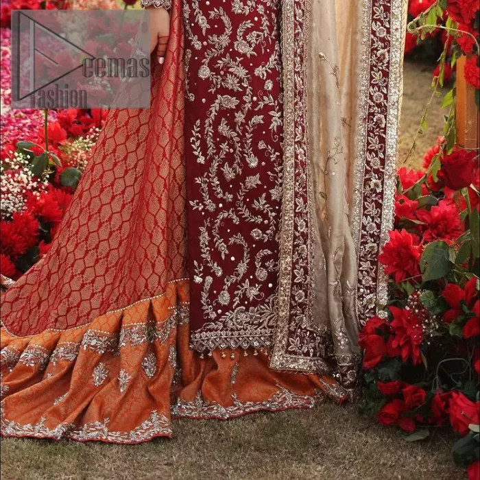 She's headstrong and rebellious, determined to divert the pacts of tradition on her Big day. Presenting a Red long shirt of DeemasFashion which is attractively ornamented with silver embroidery which involves kora, dabka, and zardozi work. It is especially highlighted with full sleeves which enhance the charmless of the article when combine with boat shape neckline. Pair up with an orange back train lehenga which is made up of pure jamawar that gives a super aesthetic and traditional look to every bride. End up this lovely look with a light golden dupatta which is embellished with a four-sided border just to fulfil the traditional gentle look. 