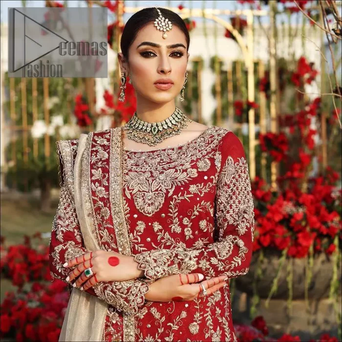 She's headstrong and rebellious, determined to divert the pacts of tradition on her Big day. Presenting a Red long shirt of DeemasFashion which is attractively ornamented with silver embroidery which involves kora, dabka, and zardozi work. It is especially highlighted with full sleeves which enhance the charmless of the article when combine with boat shape neckline. Pair up with an orange back train lehenga which is made up of pure jamawar that gives a super aesthetic and traditional look to every bride. End up this lovely look with a light golden dupatta which is embellished with a four-sided border just to fulfil the traditional gentle look. 