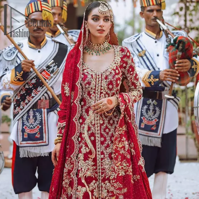 The majestic red signs a melody just for you. The handsome scalloped frock is made in the richest shade of red and specially adorned with dabka, gotta, tilla and the real magic of sequins.  It is prominent with full sleeves and the V shape neckline to introduce the bride as the shining star of the show. It is paired up with a rust lehenga to balance the article. Complete this red article with a dupatta in the same colour which is embellished with four-sided scalloped borders and floral motifs is spread all around to give you the sign of melody on your Big Day.
