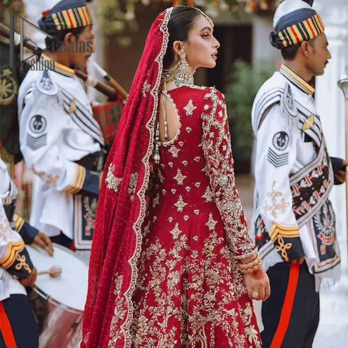The majestic red signs a melody just for you. The handsome scalloped frock is made in the richest shade of red and specially adorned with dabka, gotta, tilla and the real magic of sequins.  It is prominent with full sleeves and the V shape neckline to introduce the bride as the shining star of the show. It is paired up with a rust lehenga to balance the article. Complete this red article with a dupatta in the same colour which is embellished with four-sided scalloped borders and floral motifs is spread all around to give you the sign of melody on your Big Day.